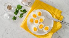 امروزه مصرف تخم‌مرغ به عنوان یکی از بهترین و کم هزینه‌ترین مواد غذایی برای دریافت پروتئین مورد نیاز بدن محسوب می‌شود و از اهمیت بالایی برخوردار است. تخم‌ مرغ منبع خوبی جهت دریافت اسیدهای آمینه ‌ضروری، آنتی‌اکسیدان‌ها و آهن است. پروتئین موجود در سفیده تخم‌مرغ با کیفیت‌ترین نوع پروتئین می‌باشد که به عنوان پروتئین استاندارد هم شناخته شده است. زرده تخم‌مرغ نیز حاوی پروتئین است و مصرف آن کلسترول خوب (HDL) را افزایش و میزان کلسترول بد(LDL) را کاهش می‌دهد و از این طریق به کاهش خطر بیماری قلبی عروقی کمک می کند. همچنین زرده تخم‌مرغ حاوی یک ماده مغذی به نام کولین است که یکی از اجزا غشاهای سلولی است و برای سنتز استیل کولین(میانجی عصبی) به کار می‌رود. تخم مرغ به واسطه قدرت سیرکنندگی، به کاهش چربی و وزن بدن کمک می‌کند. دو آنتی‌اکسیدان موجود در تخم‌مرغ به نام‌های لوتئین و زاکسنتین اثرات محافظتی قوی روی چشم‌ها دارند. مشخص شده است که پروتئین تخم‌مرغ می تواند به افزایش قد در کودکان کمک کند و از بیماری کواشیورکور محافظت می کند. پروتئین تخم مرغ برای سلامت عضلات اسکلتی و محافظت در برابر سارکوپنی (از دست رفتن و زوال توده ماهیچه) مهم است. تخم‌مرغ به سبب تامین ۲۲درصد از مقدار توصیه شده مصرف روزانه سلنیوم در بهبود سیستم ایمنی موثر است و هورمون‌های تیروئید را تنظیم می‌کند. تخم‌مرغ حاوی ویتامین های گروه ب(B۲, B۵, B۱۲,) می باشد. گروه ویتامین‌های ب به سلامت پوست، مو، چشم‌ها و کبد کمک می کنند. تخم مرغ یکی از منابع طبیعی ویتامین D است که برای جذب کلسیم ضروری است و از این طریق به تقویت استخوان‌ها و دندان‌ها کمک می‌کند. اهمیت و فایده مصرف تخم مرغ برای ورزشکاران ورزشکاران در هر رشته ورزشی به خاطر انجام فعالیت‌های بدنی نیاز به مصرف پروتئین بیشتری(جهت ساختن عضله و ترمیم بافت‌های آسیب دیده) دارند. تخم‌مرغ به عنوان یک منبع پروتئینی کامل می‌تواند بهترین گزینه برای عضله سازی در ورزشکاران باشد. تخم‌مرغ به خاطر داشتن مقدار زیادی ویتامین B۲ در آزاد سازی انرژی از مواد غذایی و در نهایت بهبود سطح انرژی ورزشکاران موثر است. مصرف تخم‌مرغ در ورزشکاران علاوه بر کمک به عضله سازی و بازسازی بافت‌های آسیب، سفیده تخم‌مرغ به سبب داشتن pH حدود ۹ (وضعیت قلیایی)، به حفظ تعادل pH بدن کمک می‌کند و سبب کاهش اسیدیته خون و عضله می شود. بهترین شکل مصرف تخم‌مرغ، شکل آب پز است. چرا که در شکل آب‌پز میزان جزب و هضم آن افزیش می یابد و کالری اضافی بابت مصرف به صورت نیمرو یا املت دریافت نمی شود. ورزشکارانی که به دنبال کاهش وزن هستند می توانند با مصرف پروتئین بویژه پروتئین موجود در سفیده تخم‌مرغ سریعتر به هدف خود برسند. یک تخم مرغ بزرگ حدود ۸۵ کالری و ۶ گرم پروتئین دارد. ورزشکاران بهتر است حدود ۱ تا ۲ ساعت قبل از شروع تمرینات و همچنین بلافاصه پس از اتمام تمرینات ورزشی می‌توانند تخم مرغ مصرف کنند. این طریقه زمان مصرف تخم‌مرغ می‌تواند به جلوگیری از تحلیل عضلات و آسیب به بافت‌های بدن کمک کند. میزان مصرف تخم‌مرغ تحت تاثیر عوامل مختلفی از جمله ژنتیک، سابقه خانوادگی، نحوه تهیه تخم‌مرغ، رژیم غذایی کلی و میزان کلسترل دریافتی از راه مواد غذایی قرار دارد. ورزشکاران و افرادی که هیچ گونه بیماری ندارند می توانند هر روز ۱ تا ۲ عدد تخم مرغ مصرف کنند. اما بهتر است ۴ روز در هفته مصرف شود. افرادی که دارای بیماری‌های قلبی عروقی، کلیوی و ... می توانند سه روز غیر متوالی در هفته تخم‌مرغ مصرف کنند. بازگشت به صفحه علم ورزش یاریزان | اهمیت مصرف تخم مرغ برای افراد ورزشکار و غیر ورزشکار دکتر رحمت اله خان محمدی | مسئول کمیته تغذیه ورزشی هیات پزشکی ورزشی استان خوزستان